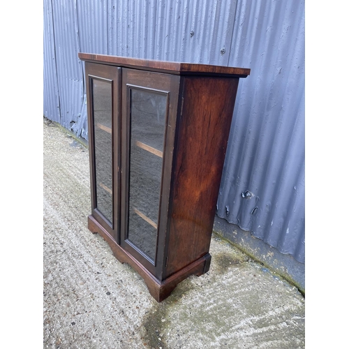 23 - A victorian rosewood two door glazed cabinet with adjustable shelves 66x36x95