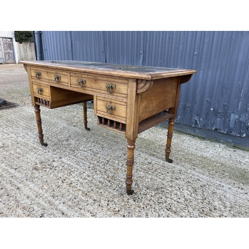 24 - An arts and crafts style oak writing table, marked CAMBRIDGE to one drawer 122x60x74