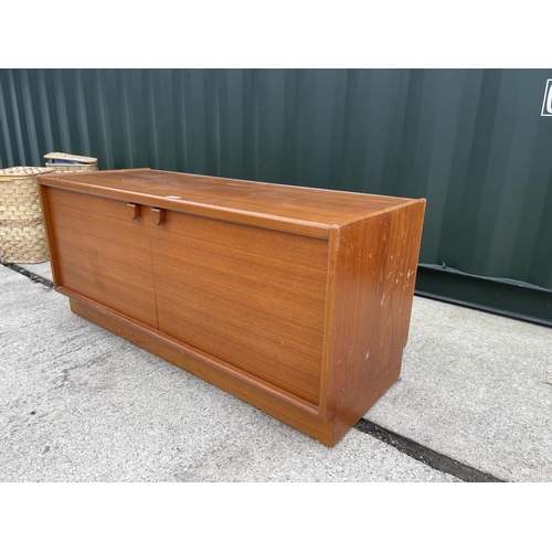 262 - A small teak two door sideboard / record cabinet by turnridge  122x45x 54