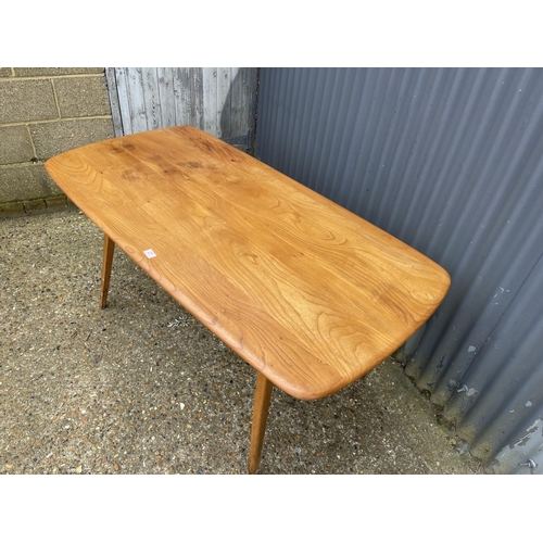 27 - An ercol light elm plank top kitchen table