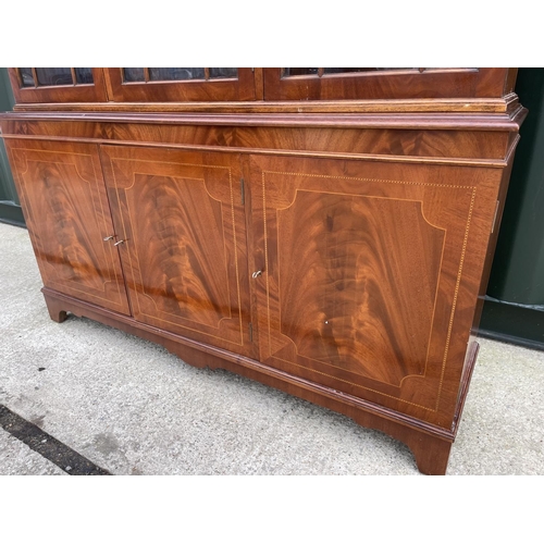 276 - A reproduction mahogany bookcase cupboard with satinwood inlaid doors  138x40x192