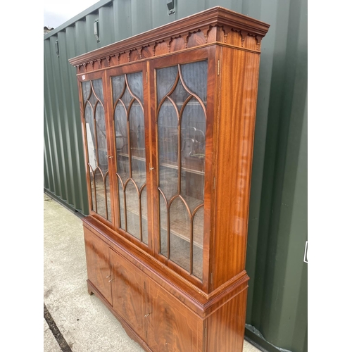 276 - A reproduction mahogany bookcase cupboard with satinwood inlaid doors  138x40x192