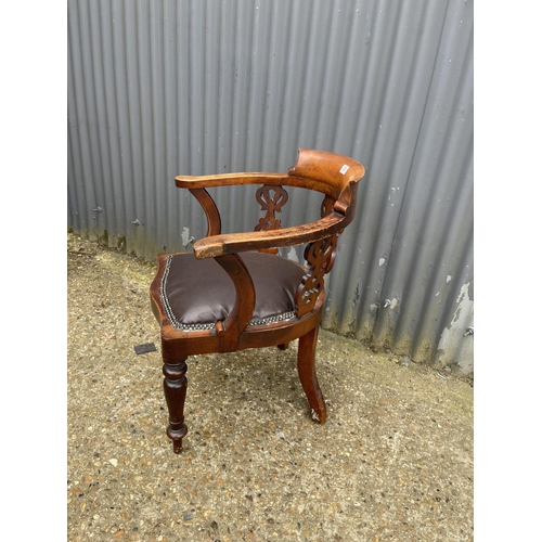 28 - A victorian smokers bow shaped elbow chair