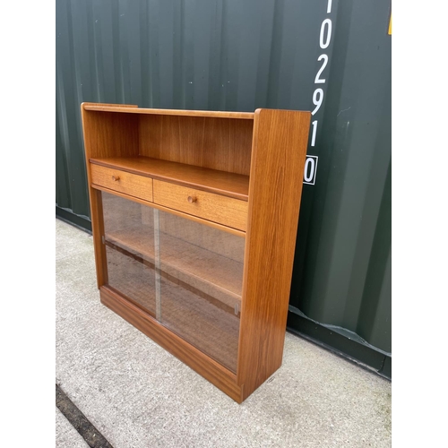 290 - A mid century teak bookcase with two drawers and glazed front 102x30x106