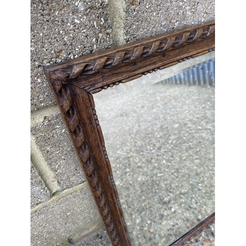 298 - A heavy oak framed mirror 85x67