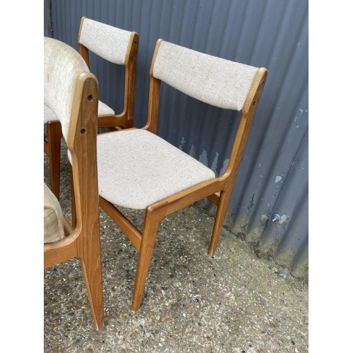 33 - A set of four danish style teak dining chairs (one with raised cushion seat)