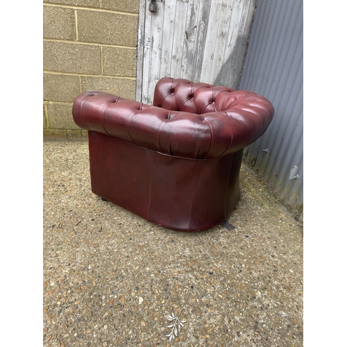 34 - An ox blood red leather chesterfield club chair