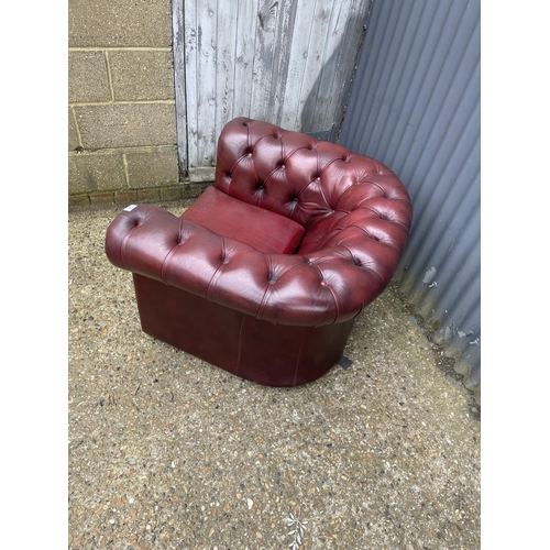 34 - An ox blood red leather chesterfield club chair