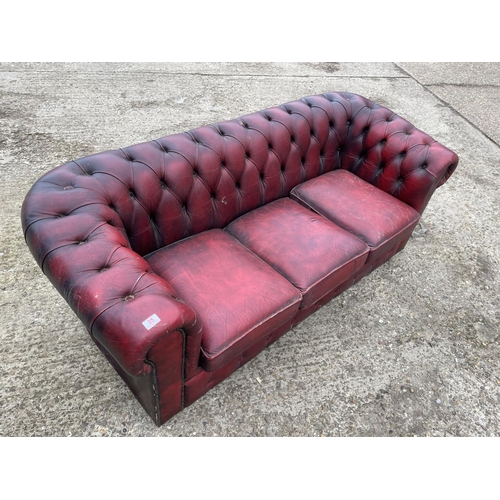 35 - An oxblood red leather chesterfield sofa