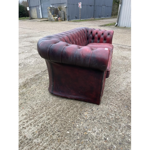 35 - An oxblood red leather chesterfield sofa