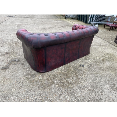 35 - An oxblood red leather chesterfield sofa