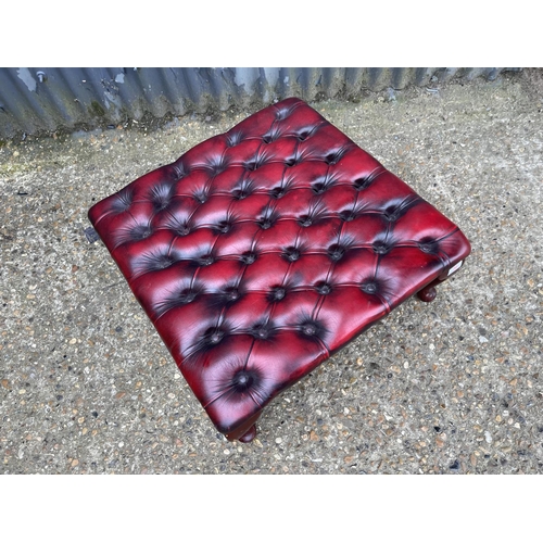 36 - An oxblood red leather chesterfield footstool 60x60x 25