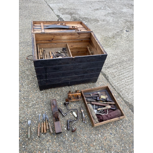 38 - An antique carpenters tool chest with assorted vintage tools including plan, chisels, axe and saws