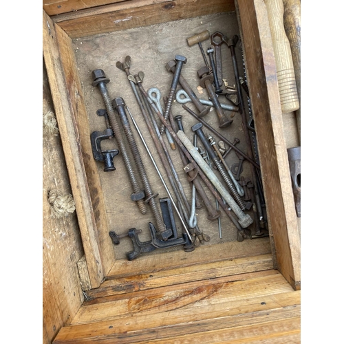 38 - An antique carpenters tool chest with assorted vintage tools including plan, chisels, axe and saws