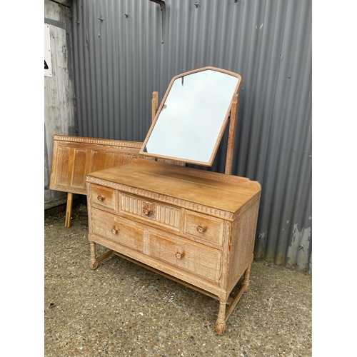 41 - A 20th century limed oak five drawer dressing chest together with matching headboard