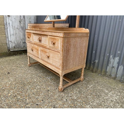 41 - A 20th century limed oak five drawer dressing chest together with matching headboard