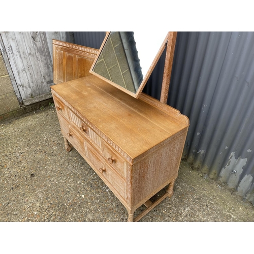 41 - A 20th century limed oak five drawer dressing chest together with matching headboard