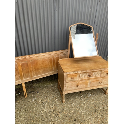 41 - A 20th century limed oak five drawer dressing chest together with matching headboard