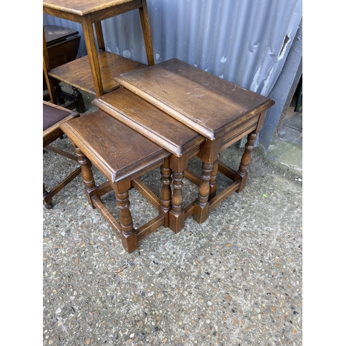 44 - AN  oak nest of three, two oak tables, stool and drop leaf table