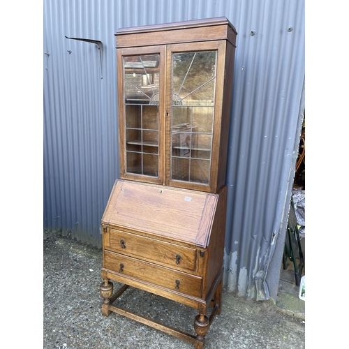 50 - An oak bureau bookcase with leaded glass top