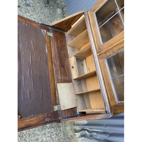 50 - An oak bureau bookcase with leaded glass top