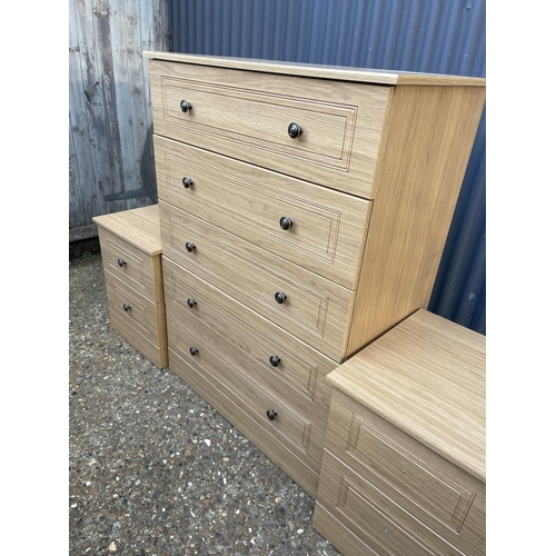 55 - A modern tallboy chest of five drawers together with a pair of matching bedsides