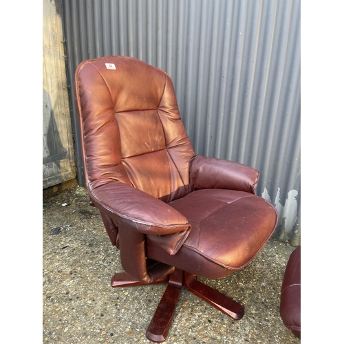 64 - A dark red leather reclining chair with footstool