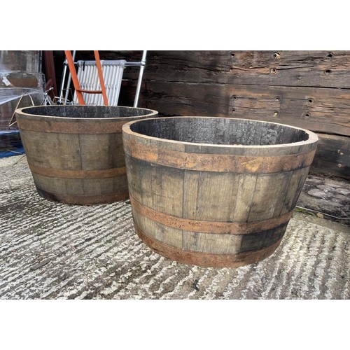 21 - A pair of scottish oak half wiskey barrell planters