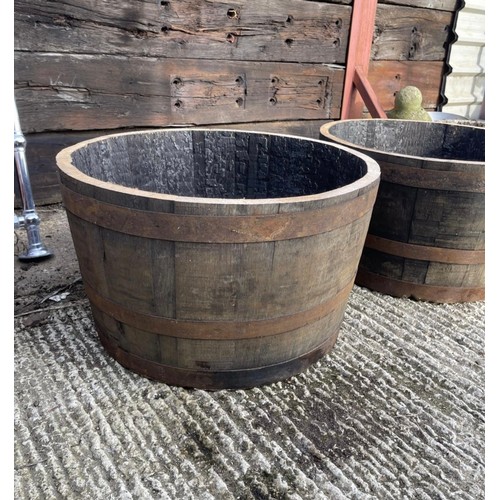 21 - A pair of scottish oak half wiskey barrell planters