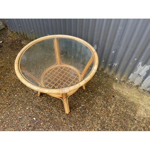 186 - A circular bamboo coffee table with drop in glass top