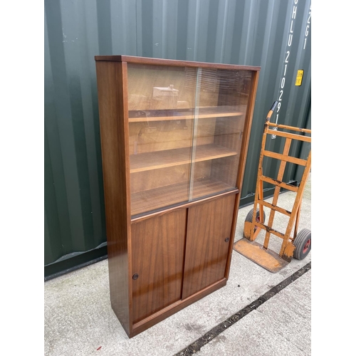 313 - A mid century teak bookcase glazed to the top half 77x27x148