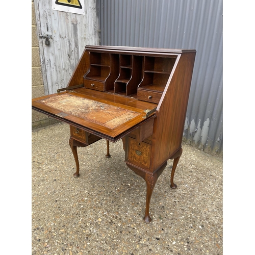 100 - A walnut bureau desk with three drawers around kneehole