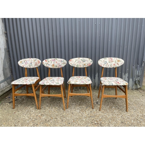 103 - A set of four vintage kitchen chairs with white upholstery