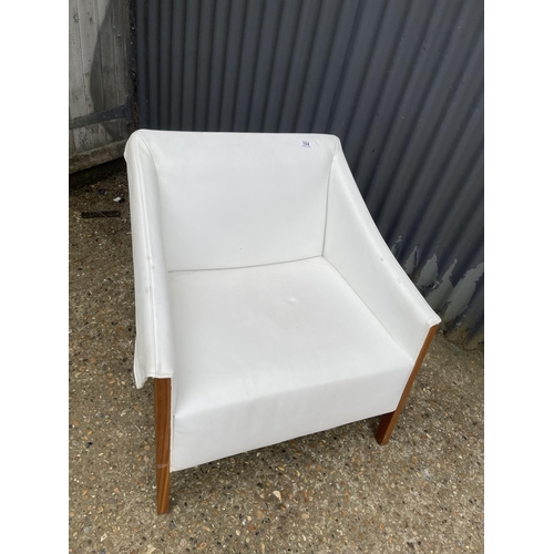 104 - A designer cream leather and teak armchair by PORADA