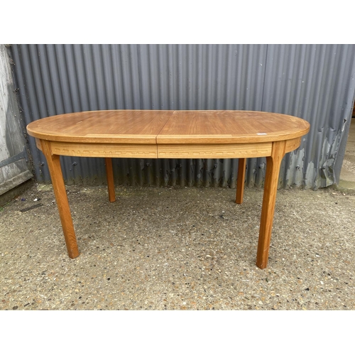 109 - An extending danish teak dining table