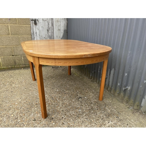 109 - An extending danish teak dining table