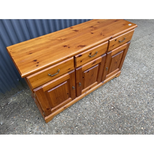 123 - A solid pine  three drawer sideboard 136x43x90