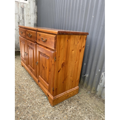 123 - A solid pine  three drawer sideboard 136x43x90