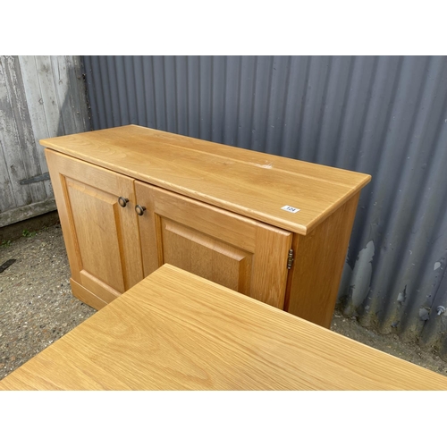 124 - A light oak two door cupboard together with a matching light oak tv stand