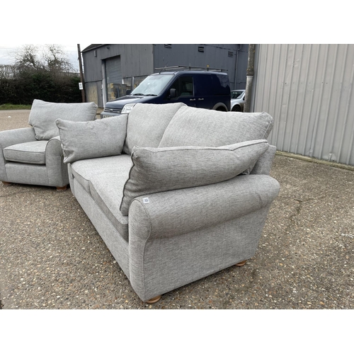 125 - A modern grey upholstered three piece lounge suite consisting on three seater sofa and two armchairs... 