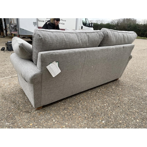 125 - A modern grey upholstered three piece lounge suite consisting on three seater sofa and two armchairs... 