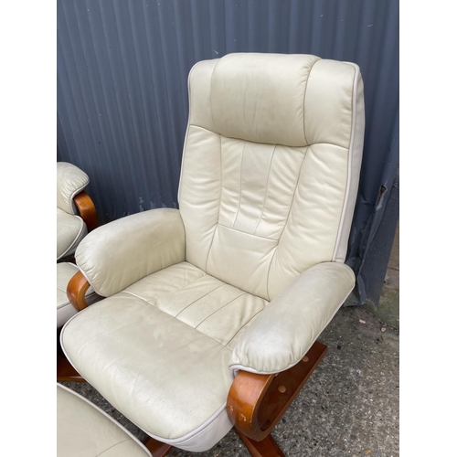 127 - Pair of cream leather easy chairs with matching footstools