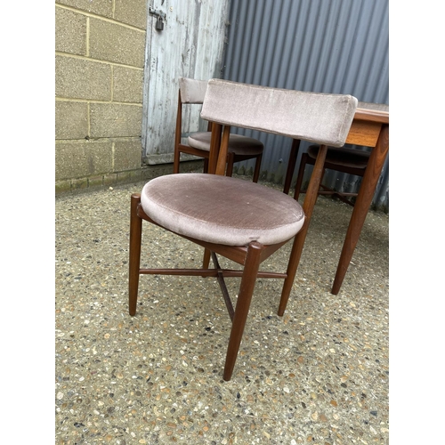 2 - A g plan teak circular dining table together with four circular seated chairs with cross stretcher