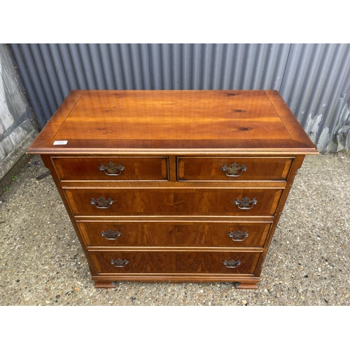 22 - A reproduction yew wood chest of five drawers 92x45x 104