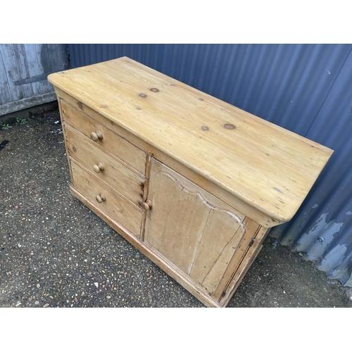 220 - An antique pine country sideboard with three drawers and door 122x52x82