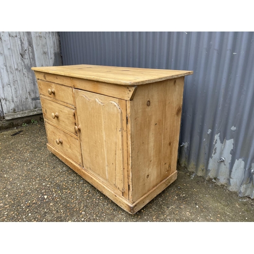 220 - An antique pine country sideboard with three drawers and door 122x52x82