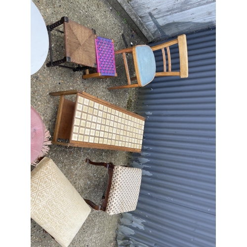 24 - A teak coffee table, five stools, table and kitchen chair