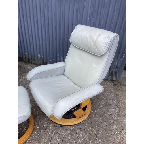 240 - A pair of grey leather reclining easy chairs with stools