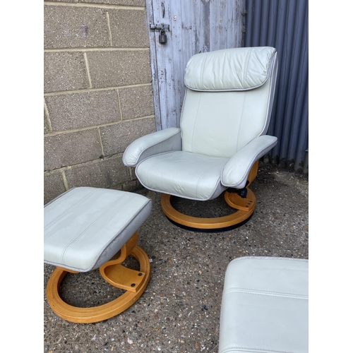 240 - A pair of grey leather reclining easy chairs with stools