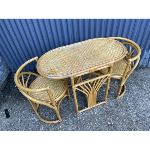 242 - A vintage style bamboo kitchen table and two chairs